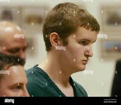 In this Feb. 9, 2004, photo, Jon Romano stands before the East Greenbush  Town Justice during his arraignment in East Greenbush, N.Y. Romano brought  a pump-action shotgun to Columbia High School and