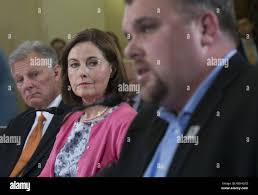 Susan and Richard Selke, parents of Iraq veteran Clay Hunt who committed  suicide, listen as Retired Army Sgt. Josh Renschler testify