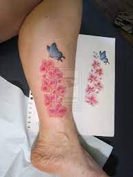 Pink Orchid With Butterfly Tattoo On Leg Tattoobite Com Pink Flower Tattoos Butterfly Tattoo Designs Orchid Tattoo