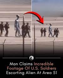 Hidden - Shocking video shared online has sparked intense debate after a  man claimed he captured footage of American soldiers escorting an alien  enтιтy inside Area 51. According to the witness, the