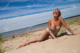 Young Sexy Woman With Nude Big Breasts On A Sandy Beach Stock Photo,  Picture and Royalty Free Image. Image 116852024.