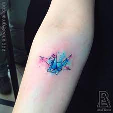 Some deliberately design crane tattoos that resemble its origami counterpart, as a sign of appreciation to the japanese legend and culture. Forearm Tattoo Of An Origami Crane With A Watercolor