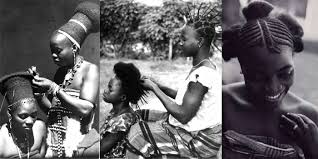 Women braiding each other's hair