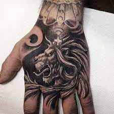 125 Best Lion Tattoos For Men Cool Designs Ideas 2021 Guide Hand Tattoos For Guys Tattoos For Guys Crown Hand Tattoo