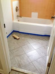 Peel and stick tile is exactly what it sounds like! Remodelaholic Bathroom Redo Grouted Peel And Stick Floor Tiles