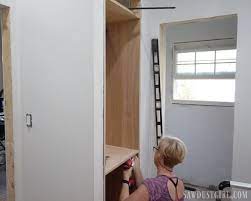 Apply glue to the edges of the cabinet sides, top, bottom, and middle shelf. Built In Linen Cabinet Sawdust Girl