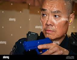 Naval District Washington Police Sgt. Ellery Bennett cuts a cake after a  retirement ceremony celebrating his 30 years of service. The event was held  at the USO Warrior and Family Center Jan.
