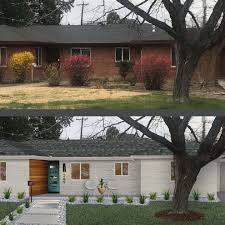 Stone balls accent the front lawn, bringing smooth texture to the busy brick exterior. Mid Century Modern Fav Ranch House Exterior Home Exterior Makeover Painted Brick House