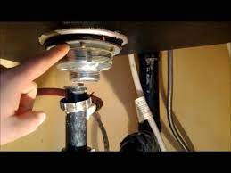 Next, put buckets under the water supply lines, disconnect the lines with an adjustable wrench, and remove the drainpipe with pliers. How To Replace A Kitchen Sink Strainer Youtube