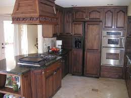 Smooth the stain on in soft strokes starting at the top and moving along with the grain of the wood. Photo Of Dark Restained Oak Cabinets Oak Kitchen Oak Kitchen Cabinets Kitchen Design