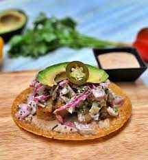 The crispy, flaky white fish, lime red cabbage slaw, and creamy tahini avocado crema make the perfect match. Special 7 Baja Fish Tacos Beer Battered Fish Tucked In To A Fresh Corn Tortilla Smuttered In Our Signature Smokey Chile Crema Sauce Topped With Shredded Cabbage Slaw Jalapenos And Avocado Introducing You