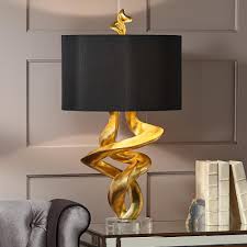 This product features a brushed steel base and a fabric shade. Table Lamps Kathy Ireland Tribal Impressions Gold Leaf Table Lamp Table Lamp Design Table Lamps Living Room Black And Gold Living Room