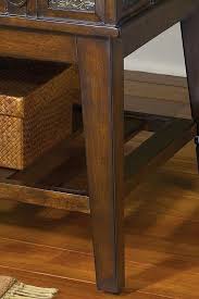 Signature design by ashley mckenna coffee table with an old world look the mckenna coffee table from signature design by ashley features a rich brown finish complete with stamped metal elements and buckled belt accents with a unique design of a slide open top for storage. Mckenna T53 By Signature Design By Ashley Becker Furniture World Signature Design By Ashley Mckenna Dealer