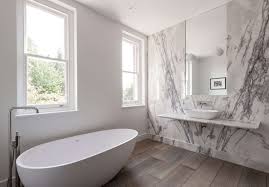 For example, this oval tub rests on a black marble platform and the shower is enveloped in white marble.{found on zackdevito}. Bathroom Of The Week In London A Dramatic Turkish Marble Bathroom For A Design Minded Couple Remodelista
