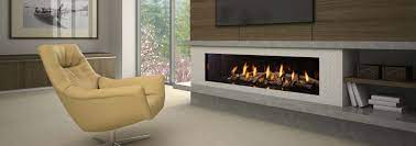 Glass media, river rock or driftwood reflected in black glass. New York View 72 Linear Modern Gas Fireplace Regency
