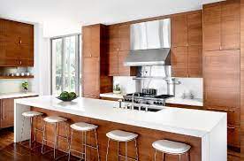 Modern Kitchen With Wood Cabinets White Caesar Stone Counters And White Barstools Contemporary Kitchen Cabinets Modern Wooden Kitchen Ikea Kitchen Design