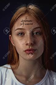 We're committed to being your source for expert health guidance. Portrait Of Young Woman With Mental Health Problems The Image Of A Tattoo On The Forehead With The Words I Desperate Self Assured Concept Of Hidding The True Feelings Psycological Trouble Stock Photo