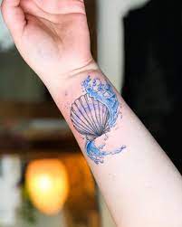 Here you can see traditional seashell tattoos, scallop seashell tattoos, tropical seashell tattoos, beach seashell tattoos, conch shell tattoos, watercolor seashell tattoos. Colourful Seashell Tattoo By Dutch Artist Captaincubetattoo Just Keep Swimming Thanks For This Dearms December Seashell Tattoos Tattoos Shell Tattoos