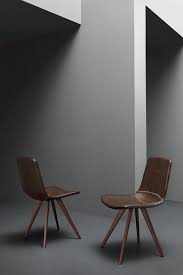 The seat is made of solid wood with a natural wood grain. Chair Upholstered In Faux Leather In Vintage Style Idfdesign