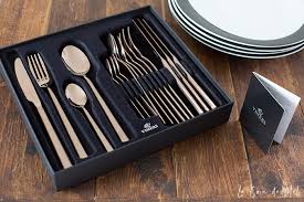 The stems of the wine glasses are in a deep blue. Black Gold Table Setting Le Coin De Mel