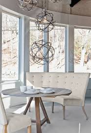 The table top and both bench seats are crafted from manufactured wood for a sophisticated contrast between the gray and black. Verellen Fermette Round Table Caroline Banquette Emanuelle Chairs Round Dining Table Modern Round Dining Room Dining Room Bench