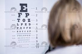 Optometrist Looking At Eye Chart License Download Or