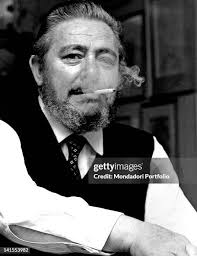 The Italian journalist Gianni Brera smoking a cigarette in his house....  News Photo