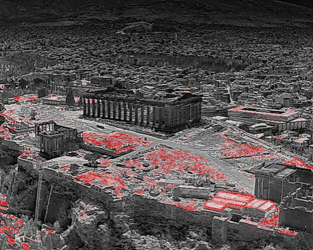 A thermal imaging view of a European cityscape during a summer heatwave, illustrating extreme temperature levels.