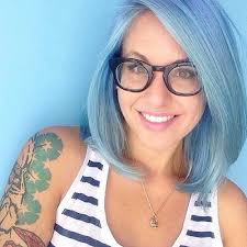 Blonde layered hair with choppy bangs on front splashed with blue, red and violet shade to create a full funky and bright look. Eye Catching Blue Hair Color Ideas On Short Hair
