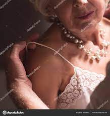 Husband undressing elderly elegant wife Stock Photo by ©photographee.eu  151199612