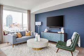 A bedroom with contrasting black and white colors looks even nicer by covering the walls with picture frames that also contains black and white photos. Mid Century Modern Living Room With Blue Wall Hgtv
