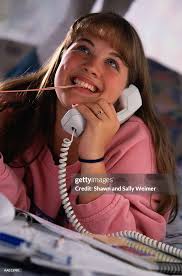 Teen Girl Talking On The Telephone With Gum High-Res Stock Photo