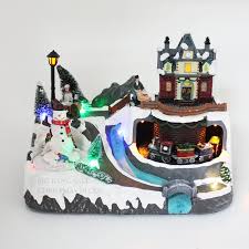 Each building facade includes interior lighting, decorative exterior lights, and three dimensional window scenes. Christmas Village Train Snowman Musical Light Up Animated Christmas Decor