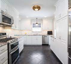 Counter goes around a corner. White Kitchen Cabinets With Black And Gray Granite Countertops Transitional Kitchen