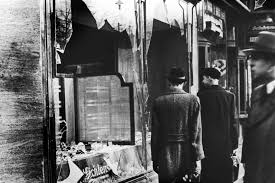 Pedestrians glance at the broken windows of a jewish owned shop in berlin after the attacks of kristallnacht, november 1938. Bearing Witness To Nazis Life Shattering Kristallnacht Npr