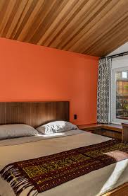 The black walls are a great background to let the bold colors stand out without making it seem disorganized. Orange Bedroom Decor Ideas Sebring Design Build