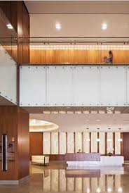 Golden Onyx And Warm Wood Materials In The Entry Lobby Add To The Facility S Hospitality Aesthetic Hospital Design Hospital Interior Healthcare Interior Design