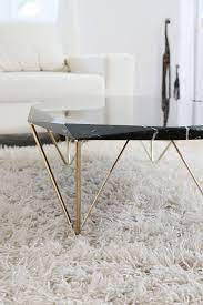 Liquid Marble Coffee Table Black Marble Coffee Table Marble Coffee Table Marble Furniture This contemporary coffee table has a black real marble top resting on uniquely crafted quad polished gold stainless steel legs.