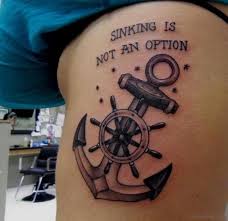 This black and white image shows a mustached man dressed in white slacks and a coat, leaning on a ships wheel. 41 Clean Compass Tattoo On Rib