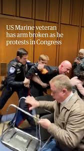 Warning: this video contains footage viewers may find upsetting., The arm of a protester was broken as security officers tried to remove him for interrupting a meeting at the US Capitol., Footage ...