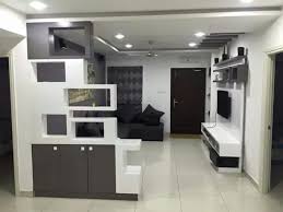 We have own showroom and store. Living Room With Black L Shaped Sofa And Tv Unit Hinged To Wall By Madhu Gunisetti