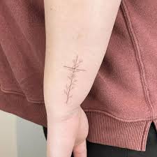 This flower, which blooms in autumn, has come to like the tree that refused to lend its wood to build jesus's cross, the dogwood flower has come to represent. Fine Line Cross With Flowers Tattoo On The Wrist