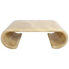 Faceted rectangular coffee table in black batik fabric with bone inlays, over pedestal base with recessed lighting, by karl springer, american 1970's. Karl Springer Style Scroll Faux Goatskin Coffee Table At 1stdibs