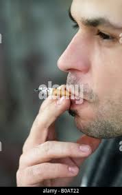 Smoking, man inhaling a cigarette, close up Stock Photo