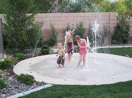 Backyard Splash Pad No Up Keep Small Footprint Cheaper Than A Pool Safer Than A Pool In The Winter Put A Fire Pi Backyard Splash Pad Backyard Backyard Fun