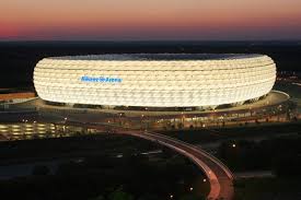This panoramic wallpaper depicts the munich, germany located soccer stadium lit up at night. Allianz Arena Herzog De Meuron