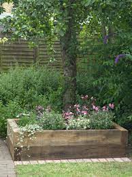 While attractive apart, when ground covers, such as ivy,. Wood Planter Bed Of Flowers In Front Of Lime Tree Raised Garden Vegetable Garden Beds Garden Beds