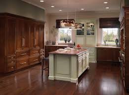 Cabinetry In Two Colors Draws Attention To The China Cabinet And Island With Chairs Highlighting Heritage And Conversat Warm Kitchen Traditional Kitchen Cabinets Kraftmaid Cabinets