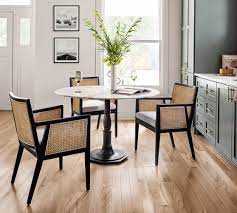 The material resembles a textured synthetic suede. Lisbon Cane Dining Armchair Pottery Barn