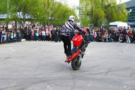 Maybe you would like to learn more about one of these? Moto Free Style Pilot On The Red Motorcycle Stunting On The Square Stock Photo Picture And Royalty Free Image Image 106218462